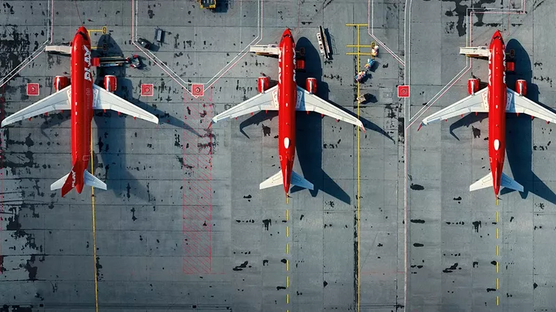 Vista cenital de aviones de la aerolnea Play estacionados en una pista.